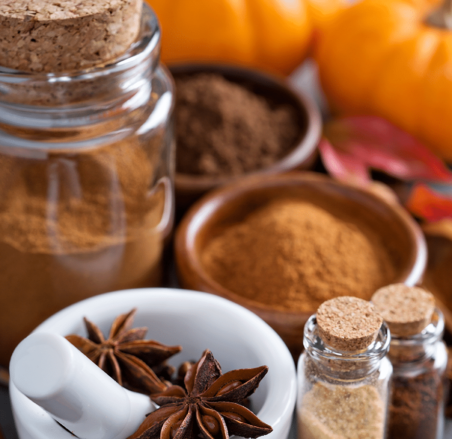 Autumn spices displayed with pumpkins